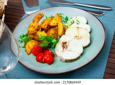 Steamed Cornish Salmon Steaks Served With Fried Potato Wedges, Pickled Tomatoes And Greens