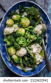 Steamed Cruciferous Vegetables And Greens In A Large Oval Dish.