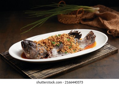 Steamed Dragon Tiger Grouper Fish With Preserved Turnip Served In A Dish Side View On Dark Background