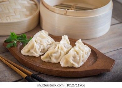 Steamed Dumplings On Wooden Plate