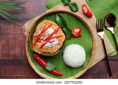 Steamed Fish Curry In Banana Leaf Cups Served With White Rice - Famous Thai Food Called Hor Mok Or Fish Amok At Top View On Wooden Background