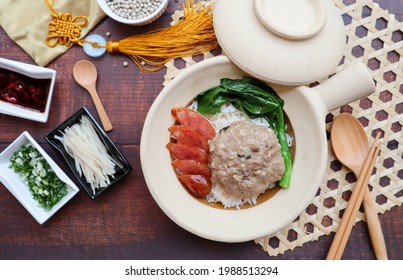 Steamed Pork Cake With Salted Fish Over Rice In A Claypot Of Wood Table - Chinese Food Called Yee Jeng Yook Baeng Or Xian Yu Zheng Rou Bing At Top View