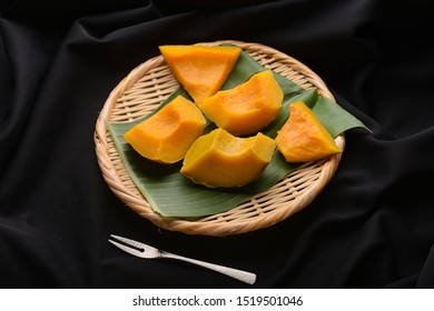 steamed pumpkin on bamboo dish.