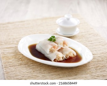 Steamed Rice Rolls with Fresh Prawn Filling with chopsticks served in a dish isolated on mat side view on grey background