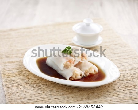 Steamed Rice Rolls with Fresh Prawn Filling with chopsticks served in a dish isolated on mat side view on grey background