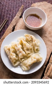 Steamed Wonton Dumpling Stuffed With Minced Pork On Plate Eating With Sesame Oil Sauce, Asian Food, Table Top View