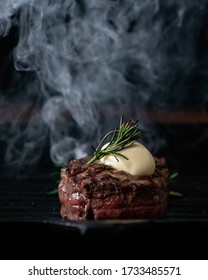 A steaming beef tenderloin steak is grilled in a grill pan with copy space. The concept of the recipe, filet Mignon