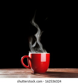 Steaming coffee cup on dark background - Shutterstock ID 162536324