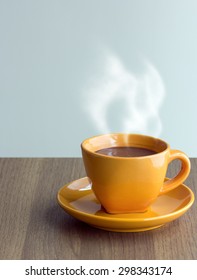 Steaming Coffee Cup On Table