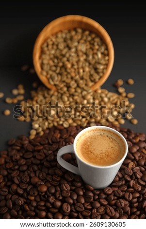 A steaming coffee cup surrounded by green and roasted beans, representing the journey of coffee from raw to brewed