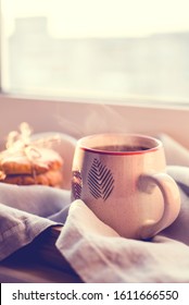 A Steaming Cup Of Tea Or Coffee With Cookies By The Window In The Sunlight.