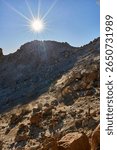 Steaming geothermal vents releasing gas inside the crater of Pico del Teide with mineral deposits and scattered rocks