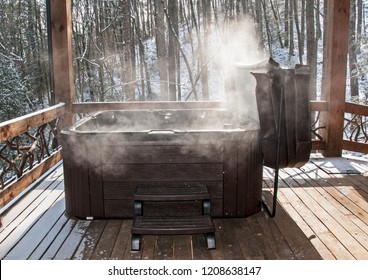Steaming hot tub on deck with snow in background