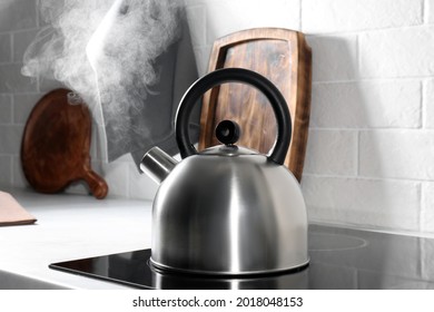 Steaming kettle on electric stove in kitchen - Powered by Shutterstock