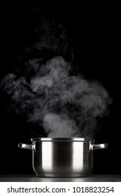 Steaming Pot On Black Background