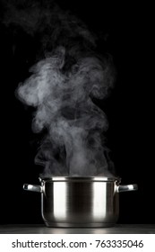 Steaming pot on black background - Shutterstock ID 763335046