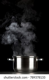 Steaming Pot On Black Background