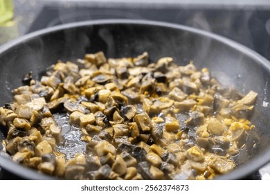 steaming skillet with sautéed mushrooms and onions cooking on a stovetop - Powered by Shutterstock