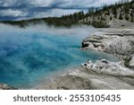  Steaming turquoise hot spring amidst rugged wilderness.