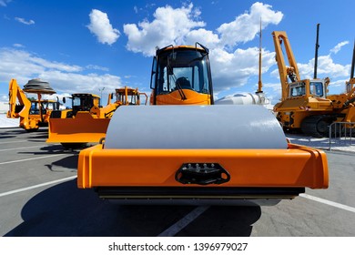 Steamroller for road works, bulldozer, tractor, loader, crane and other construction machines, heavy industry, blue sky and white clouds on background