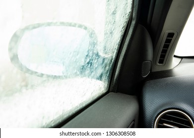 Steamy Car Window Makes It Difficult To Look In The Car Mirror. Winter Cold Day.