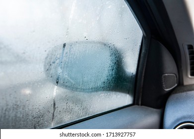 Steamy car window on a autumn rainy/foggy day. Concept of safety driving problem