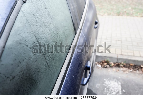 Steamy car window on a autumn rainy/foggy day.\
Concept of safety driving\
problem.