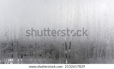 Steamy window with water drops on surface of shower cabin as background blurred Image
