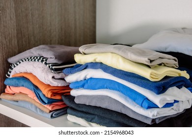Stecks of multicolored light clothes to the closet