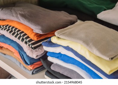 Stecks of multicolored light clothes to the closet