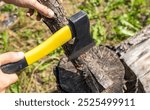 Steel axe, metal ax for wood chopping. Man holding heavy ax. Axe in lumberjack hands chopping or cutting wood trunks. A man is chopping wood.