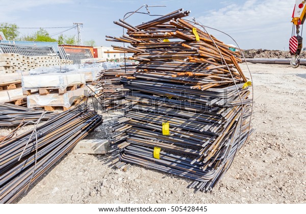 Steel bars stacked for construction,\
classified by the bending shape at construction\
site.
