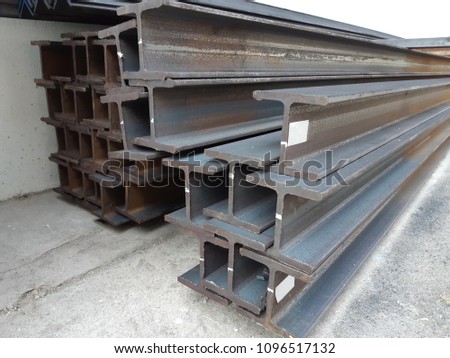 Steel beam lay on concrete floor in stack