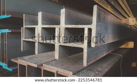 Steel beams production. Metal girders stack on project construction , steel h-beam, selective focus, Raw materials used in building construction.