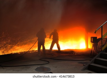 Steel blast furnace taphole spewed molten iron - Shutterstock ID 414673813