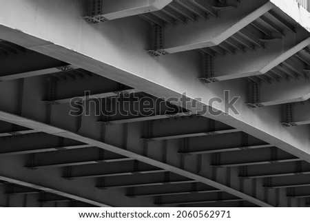 Steel bridge span construction, bottom view with gray girders 