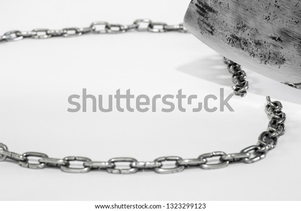 The steel chain is cut by a metal blade on a\
light gray background. A broad concept of breaking the vicious\
circle, gaining independence,\
winning.