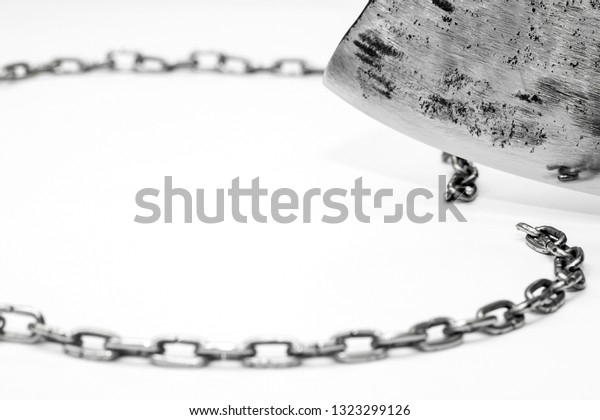 The steel chain is cut by a metal blade on a\
light gray background. A broad concept of breaking the vicious\
circle, gaining independence,\
winning.