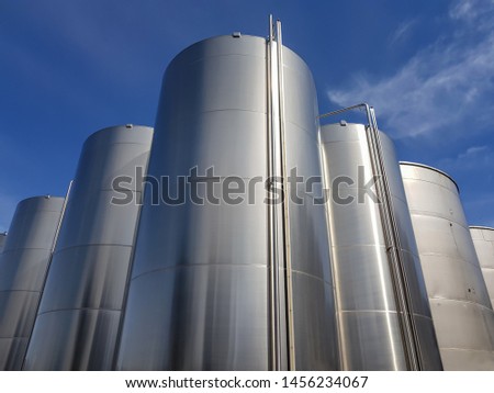 Steel clear tanks in the open air lined up in diamond shape dominate the camera
