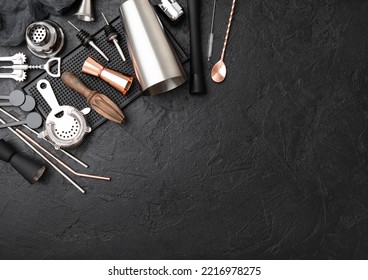 Steel Cocktail Shaker,strainer,jigger And Wooden Juicer With Muddler On Black Rubber Bar Tray.Various Bar Utensils