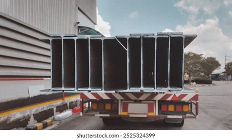 steel construction products H-beam on transport vehicle.iron steel store in warehouse heavy industry.metal warehouse industry, delivery to customers. - Powered by Shutterstock