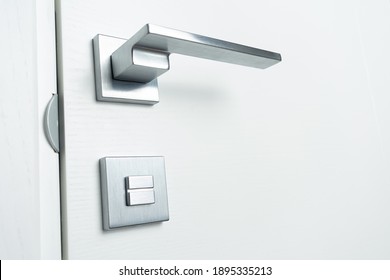 Steel Door Handle And Lock On White Wooden Door