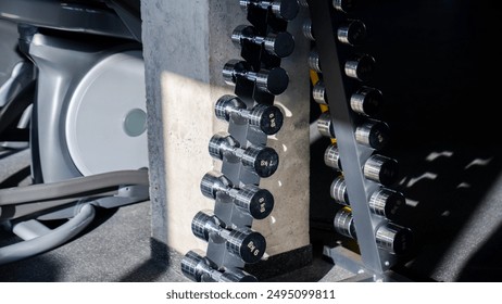 Steel dumbbell set. Close up of dumbbells on rack in sport fitness center. Workout training and fitness gym concept - Powered by Shutterstock