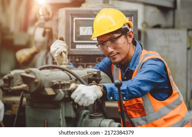 Steel factory staff worker Asian man work in a heavy industrial machine with safety engineer uniform. - Powered by Shutterstock