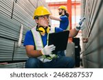 Steel factory workers using tablet check stock of steel tubes at the product placement point in iron factory.