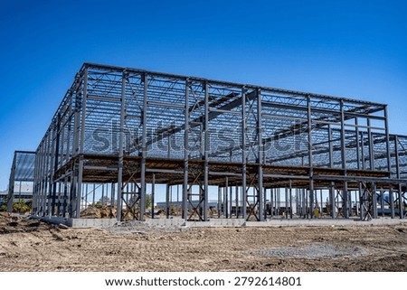 Steel frame structure under construction at industrial site.