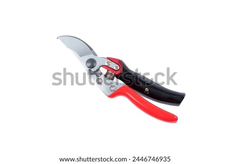 Steel gardening secateurs, scissors tool with red and black grip for pruned of plants and flowers garden work, isolated on white background. Close state. Top view. Close-up.