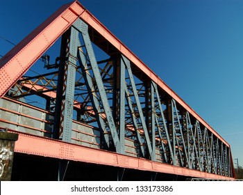 Steel girder railway bridge crossing main west coast line next to Grand Union Canal, London, England, UK