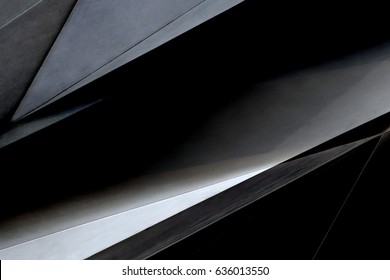 Steel and glass panels. Tilt close-up photo of office building fragment in darkness. Abstract background in black colors on the subject of modern architecture