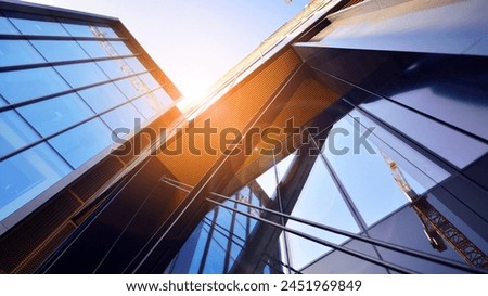 Steel and glass. The subject of modern architecture or construction industry. Modern office building facade with tall steel construction elements and full height windows between.